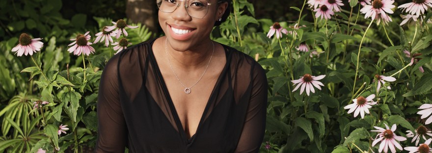 Black woman sitting with flowers